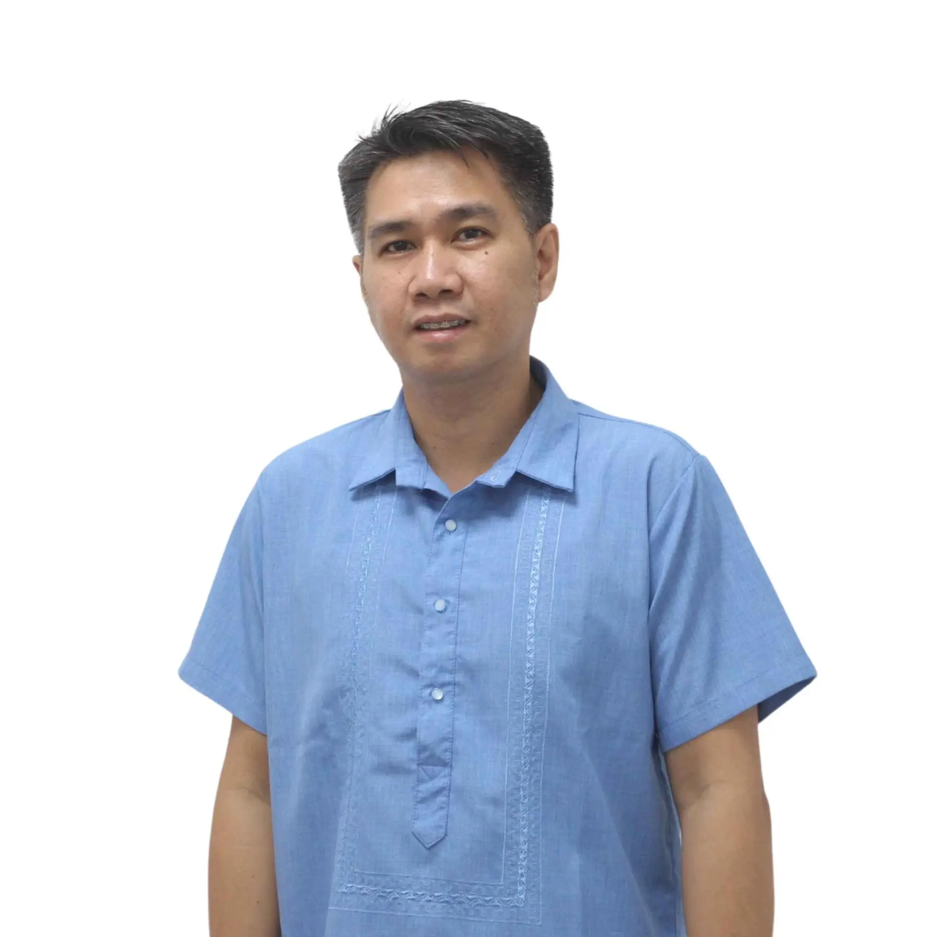 Male team member wearing a traditional light blue shirt, standing against a plain background.