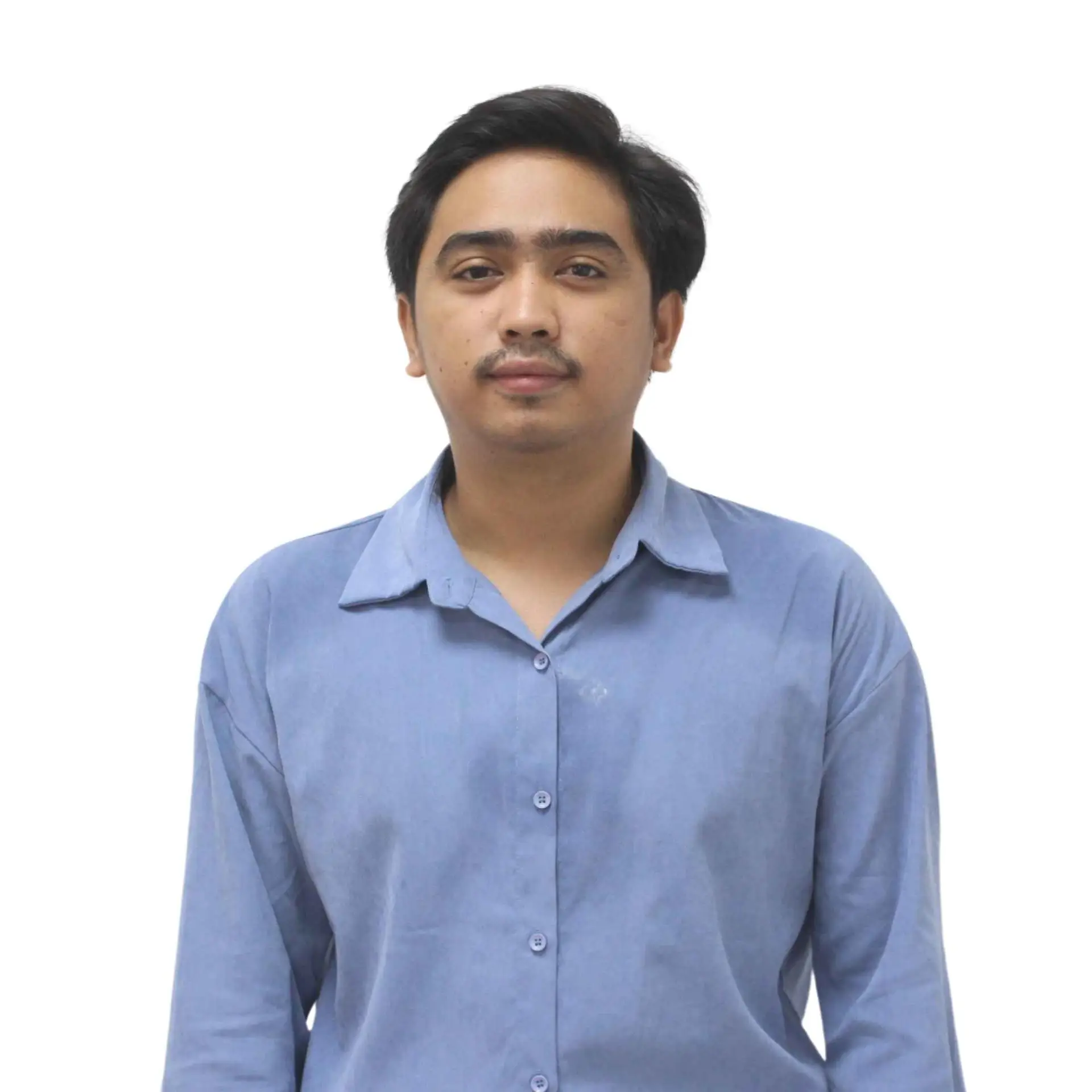 Portrait of a male team member in a light blue shirt, standing with a neutral expression.