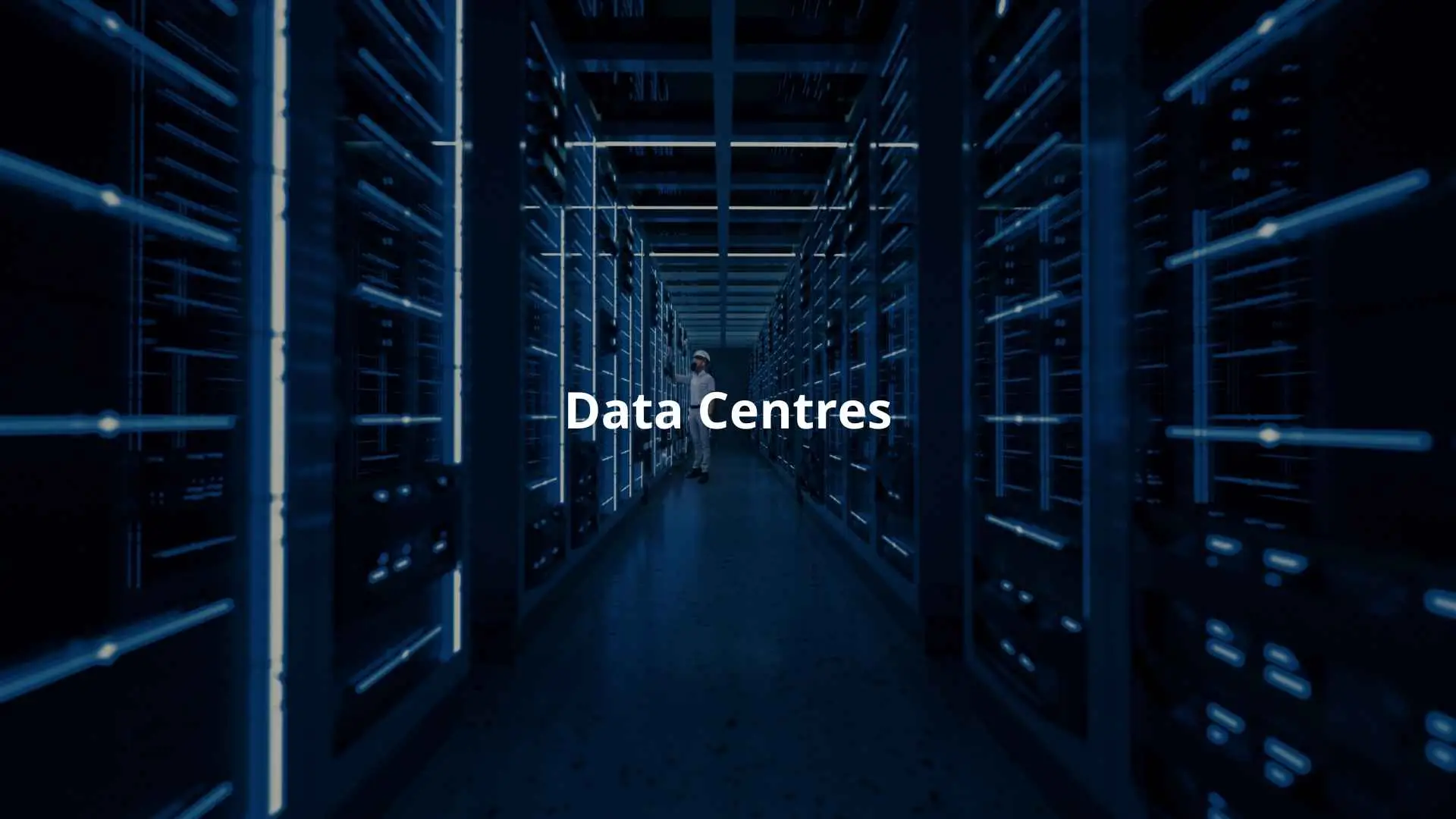 A technician inspects server racks in a data centre, surrounded by illuminated equipment.