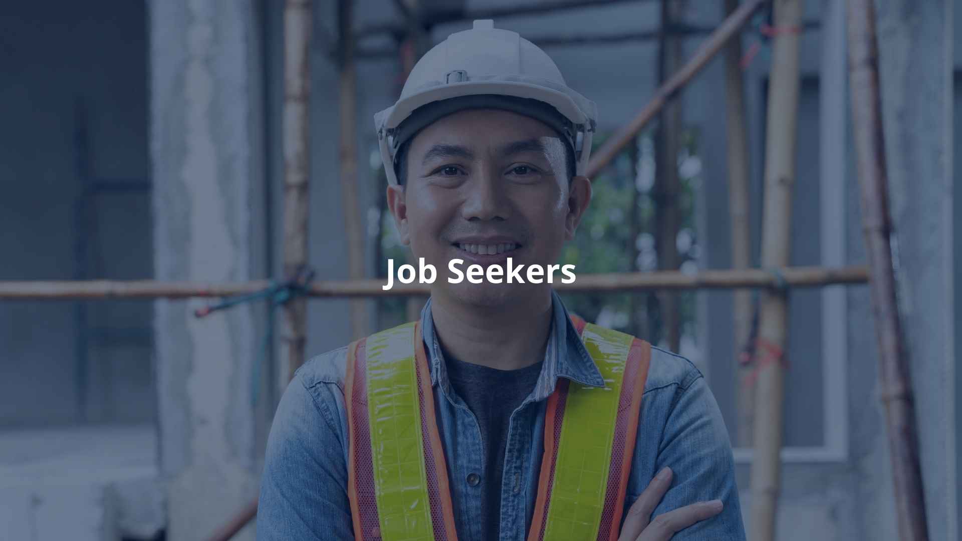 A confident construction worker wearing a safety helmet and vest, representing job seekers.